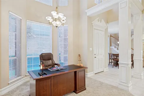 a view of a workspace with furniture and a chandelier