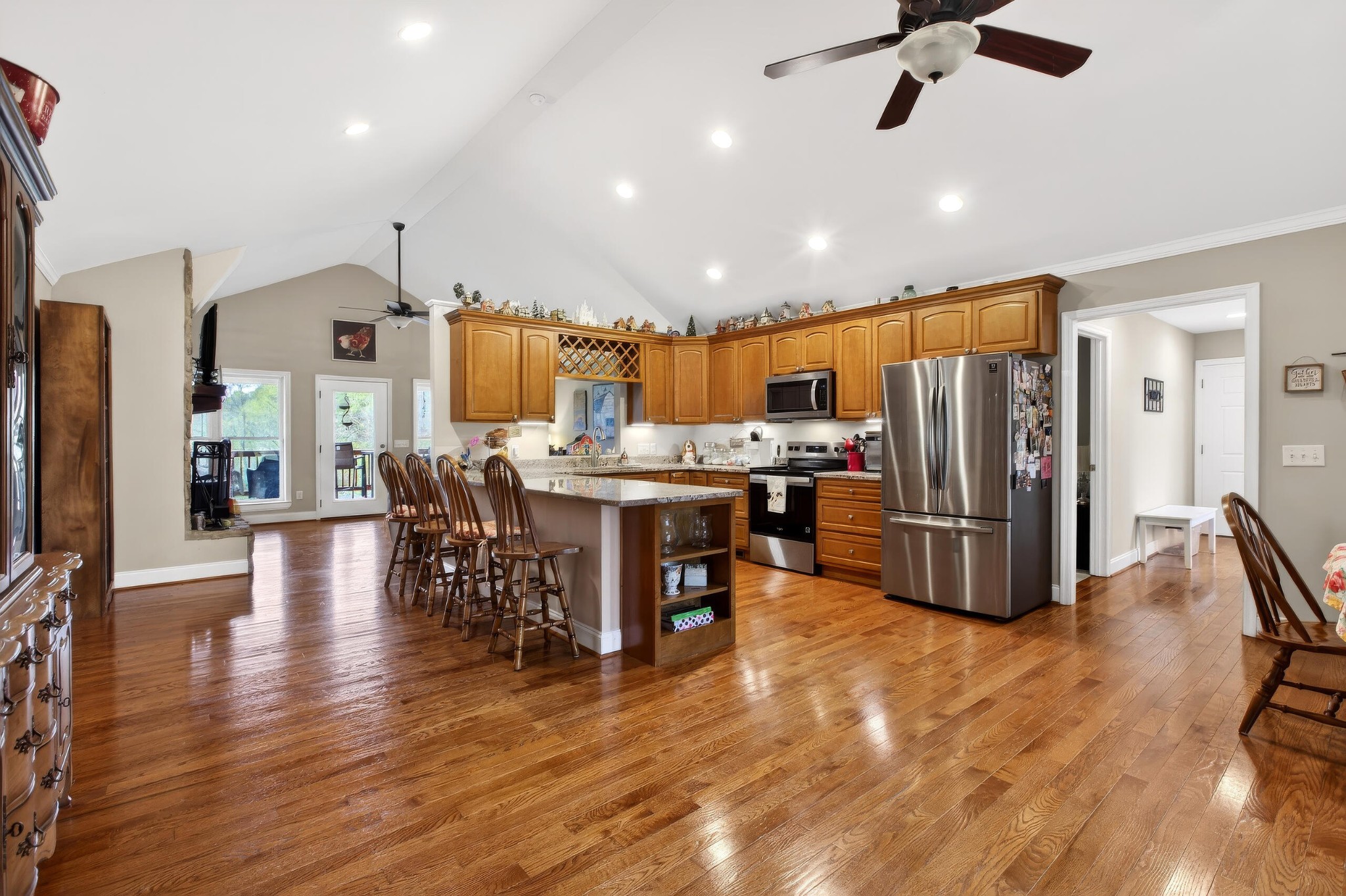 2181 Curbow Bridge Road Old Fort, TN 37362 - Photo 11 of 56 a kitchen with stainless steel appliances kitchen island granite countertop a refrigerator a stove a sink a dining table and chairs with wooden floor