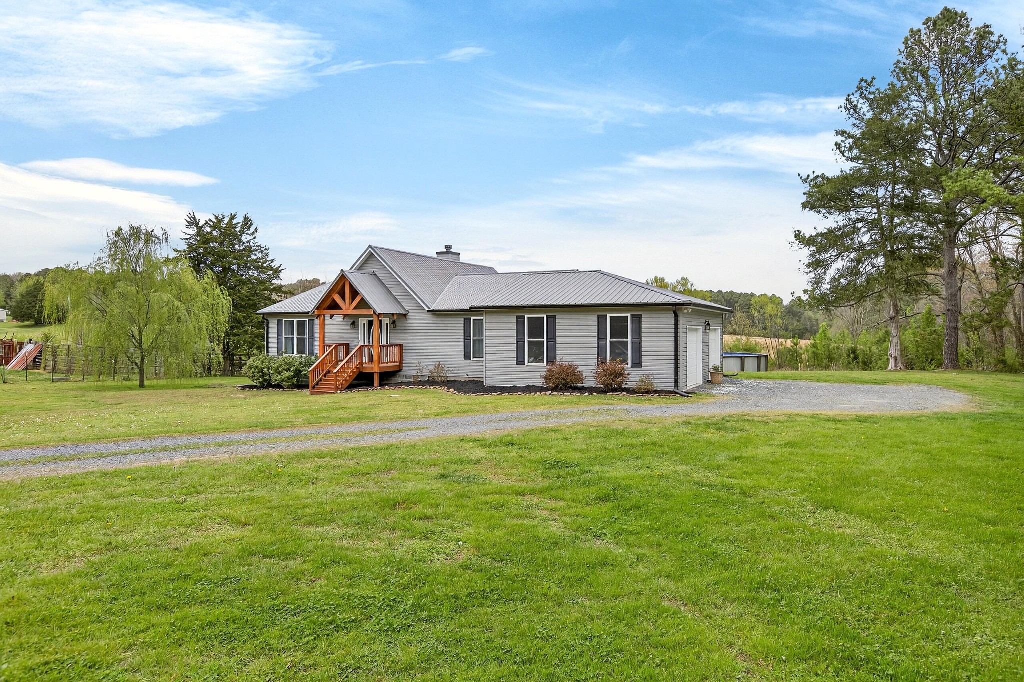 2181 Curbow Bridge Road Old Fort, TN 37362 - Photo 3 of 56 a front view of a house with a garden