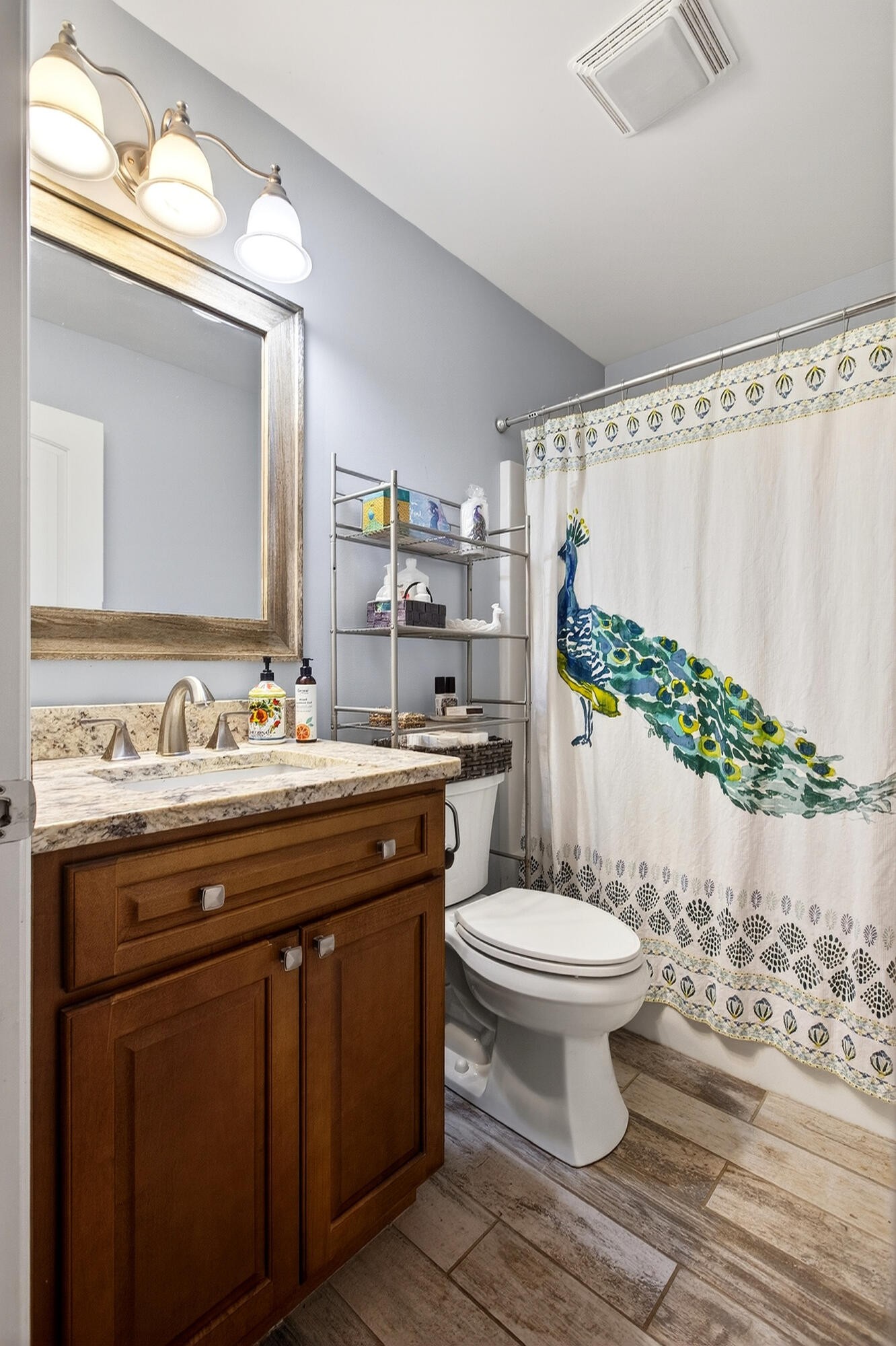 2181 Curbow Bridge Road Old Fort, TN 37362 - Photo 34 of 56 a bathroom with a granite countertop toilet a sink and a mirror