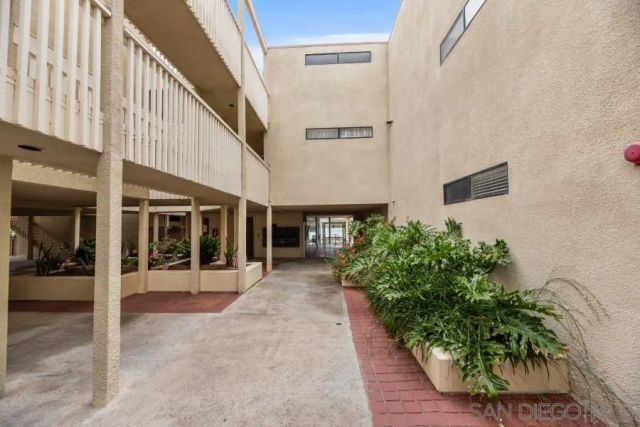 a kitchen with stainless steel appliances granite countertop a sink a stove a refrigerator cabinets and chairs