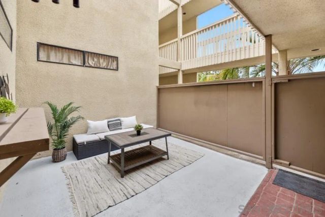 a living room with furniture and a dining table with kitchen view