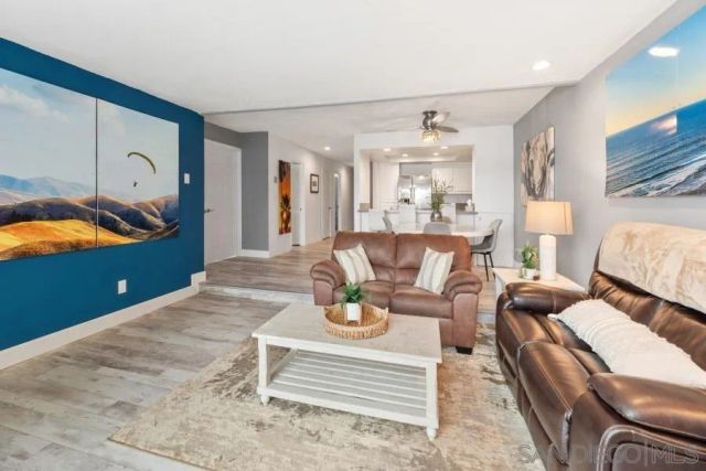 a view of a bedroom with wooden floor and bathroom