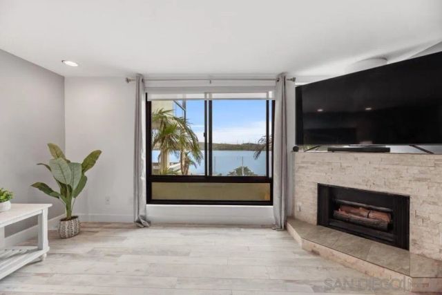 a living room with a fireplace and a flat screen tv