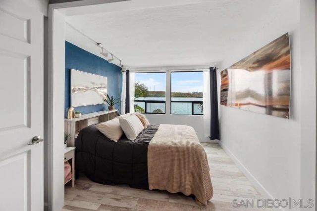 a bedroom with a bed and a night stand