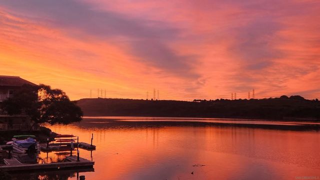 a view of a lake with a table and chairs
