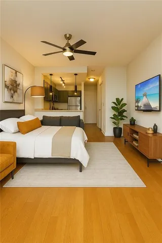 a bedroom with a bed and ceiling fan