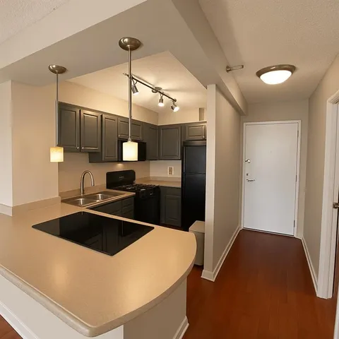 a kitchen with a sink a counter top space and stainless steel appliances