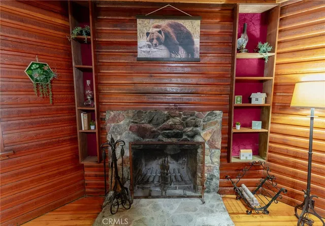 a living room with furniture a fireplace and a wooden floor