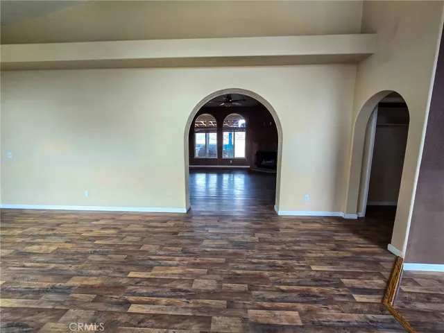 a view of an empty room and wooden floor
