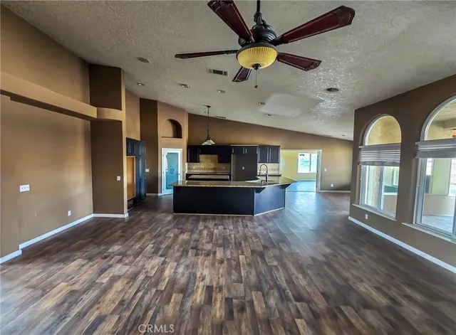 a kitchen with kitchen island granite countertop wooden cabinets and granite counter tops