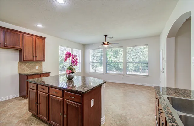 a kitchen with stainless steel appliances granite countertop a sink dishwasher and cabinets with wooden floor