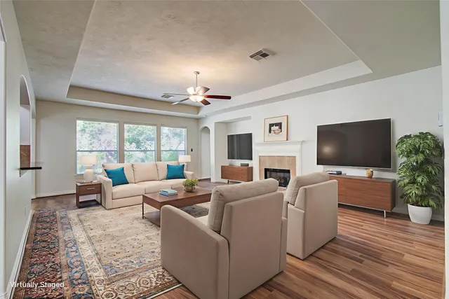 a living room with furniture a large window and a flat screen tv