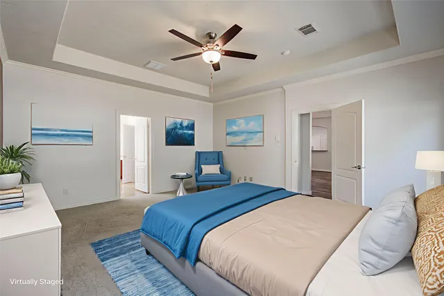 a bedroom with a large bed and a chandelier