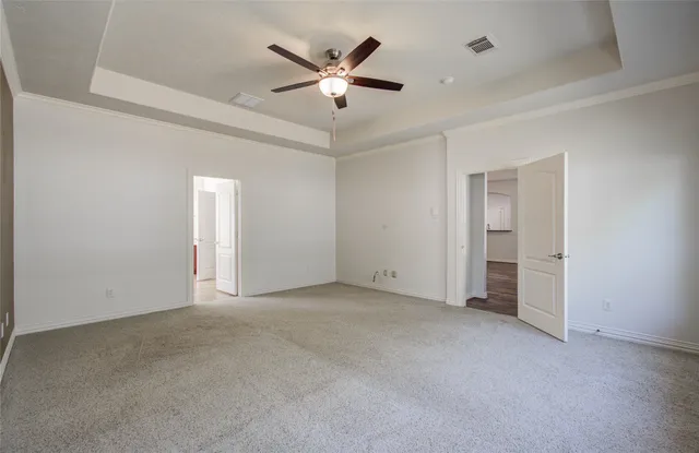 an empty room with closet and ceiling fan