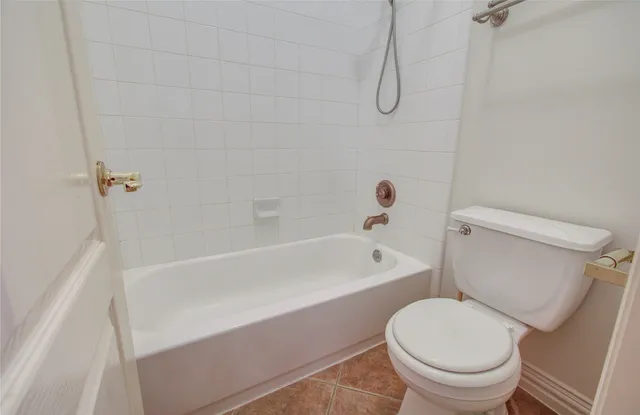 a bathroom with a toilet and a bath tub