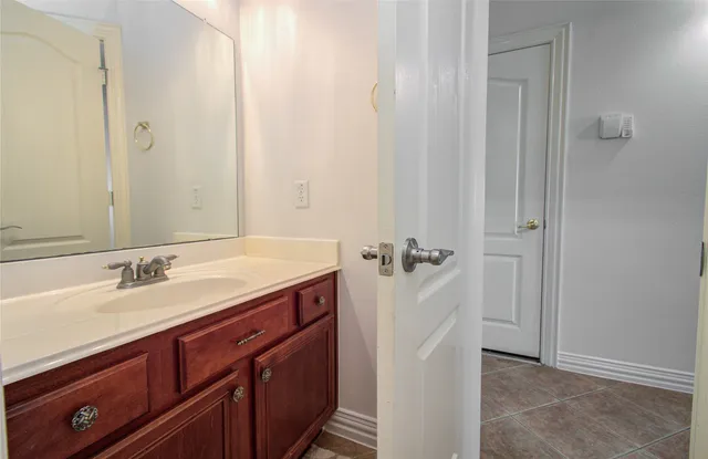 a spacious bathroom with a double vanity sink and mirror