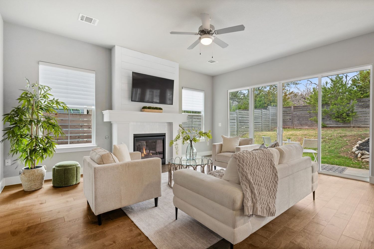 Light filled Living room with cozy fireplace and hardwood floors