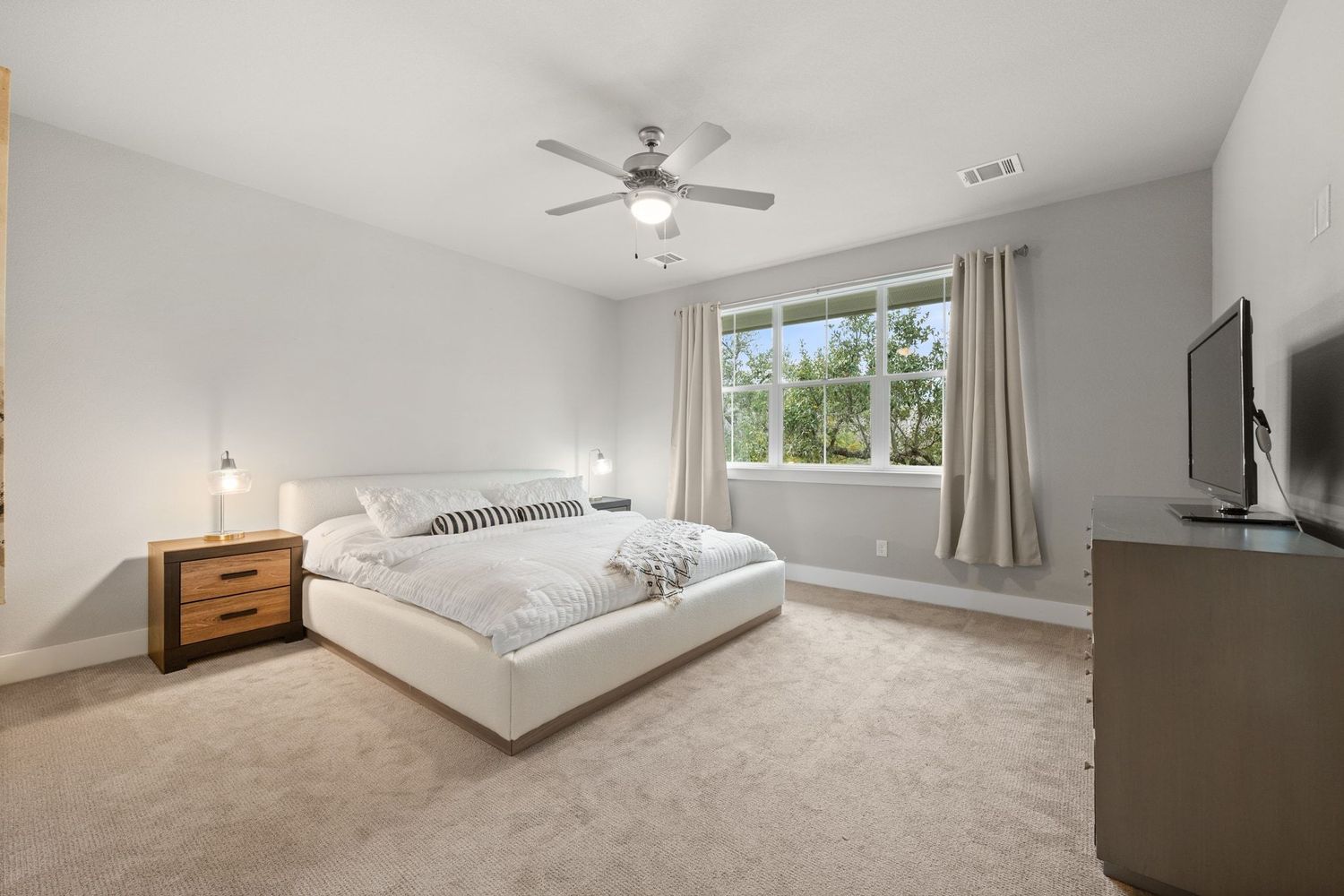 7806 Ryans Way Austin, TX 78726 - Photo 6 of 21 Upstairs spacious Primary bedroom with a view of the trees