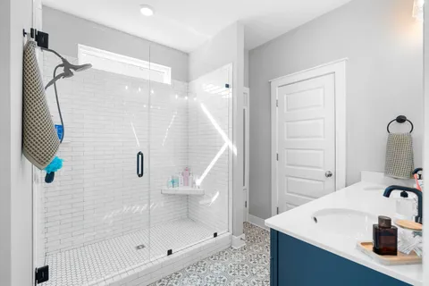 a bathroom with a double vanity sink and a mirror