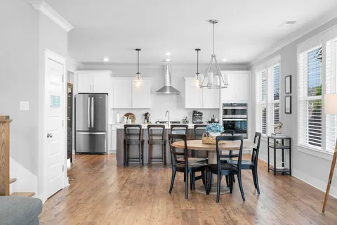 a living room with fireplace furniture and a wooden floor