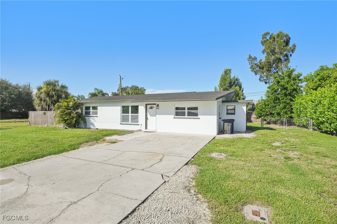 18472 Iris Road Fort Myers, FL 33967 - Photo 1 of 27 a front view of a house with a yard and garage