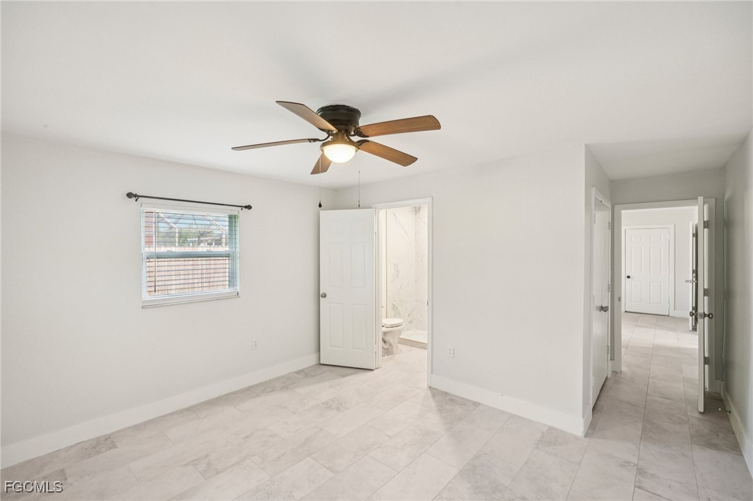 18472 Iris Road Fort Myers, FL 33967 - Photo 11 of 27 an empty room with ceiling fan and window