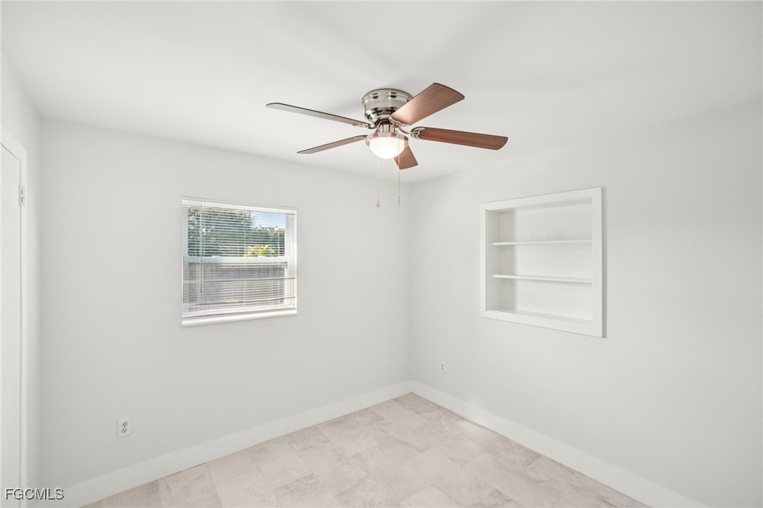 18472 Iris Road Fort Myers, FL 33967 - Photo 16 of 27 an empty room with windows and fan