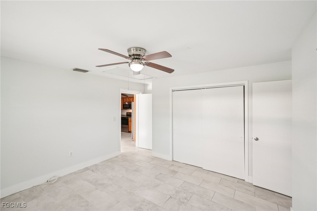 18472 Iris Road Fort Myers, FL 33967 - Photo 21 of 27 an empty room with fan and a ceiling fan