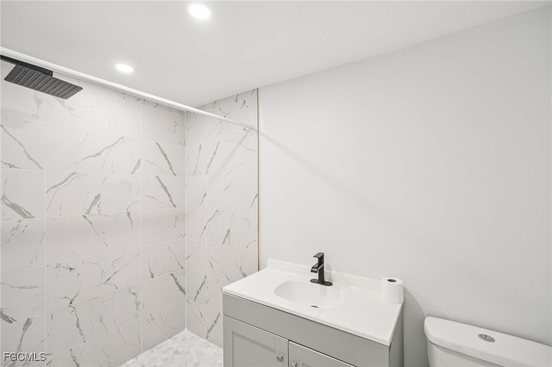 18472 Iris Road Fort Myers, FL 33967 - Photo 22 of 27 a bathroom with a sink toilet and vanity