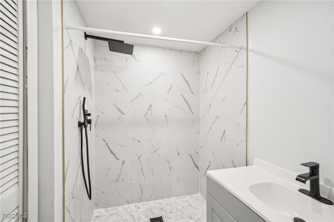 18472 Iris Road Fort Myers, FL 33967 - Photo 23 of 27 a bathroom with a sink and a mirror
