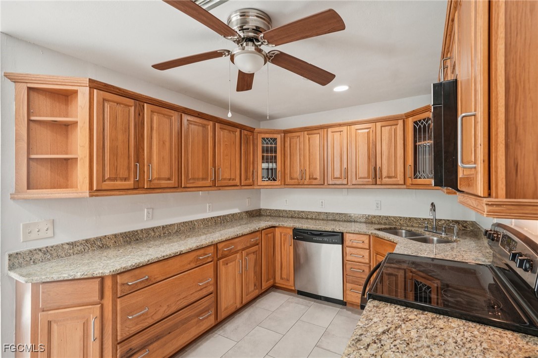 18472 Iris Road Fort Myers, FL 33967 - Photo 6 of 27 a kitchen with a sink stove and cabinets