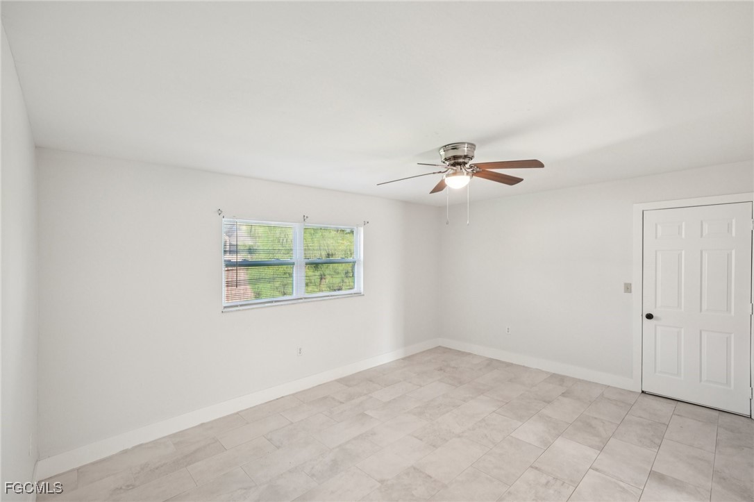 18472 Iris Road Fort Myers, FL 33967 - Photo 8 of 27 an empty room with windows and fan