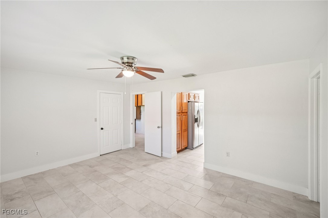 18472 Iris Road Fort Myers, FL 33967 - Photo 9 of 27 an empty room with closet and ceiling fan