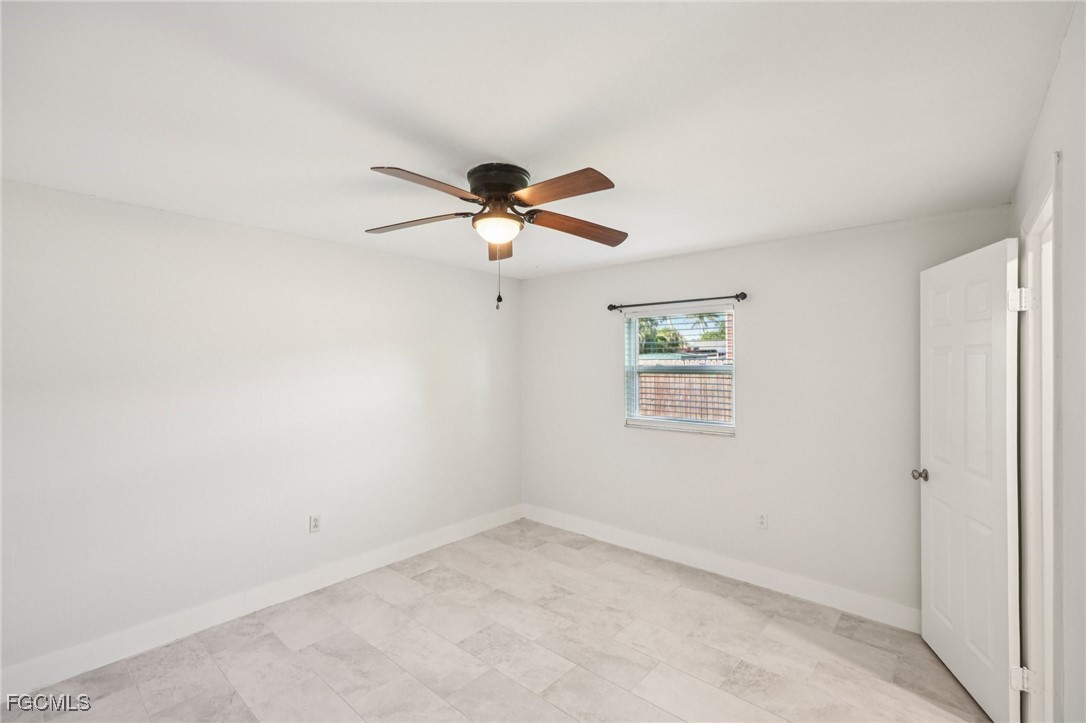 18472 Iris Road Fort Myers, FL 33967 - Photo 10 of 27 an empty room with a window and a fan