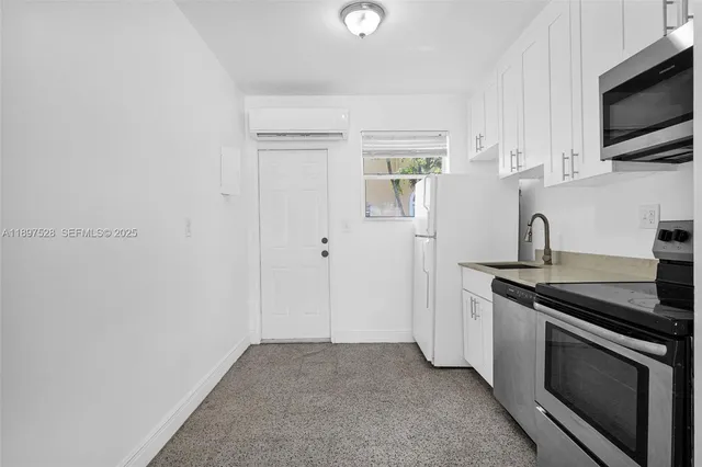 a kitchen with stainless steel appliances a sink stove and microwave