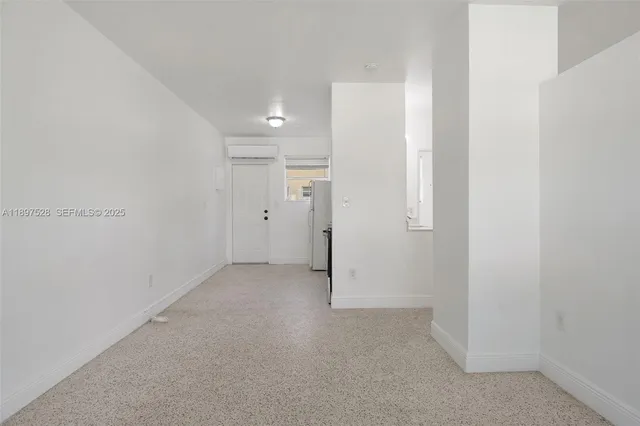 a view of a kitchen with white cabinets and stainless steel appliances