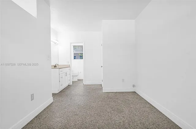 a white toilet sitting next to a bathroom sink