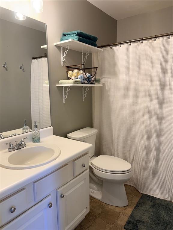 59 Indian Hills Drive Rydal, GA 30171 - Photo 17 of 35 a bathroom with a sink a toilet and shower curtain