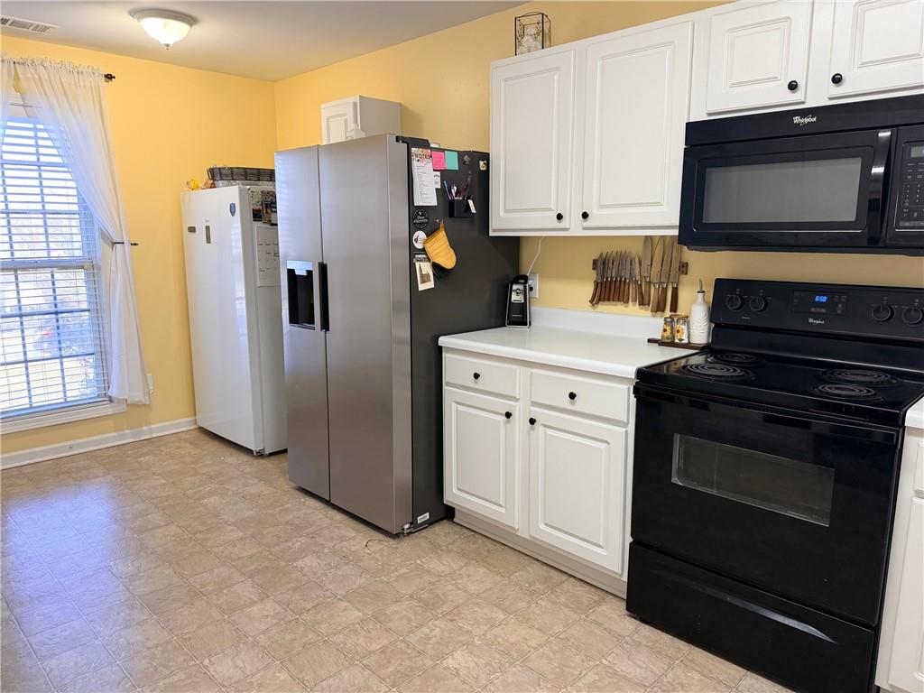 59 Indian Hills Drive Rydal, GA 30171 - Photo 7 of 35 a kitchen with stainless steel appliances a stove a microwave and a refrigerator