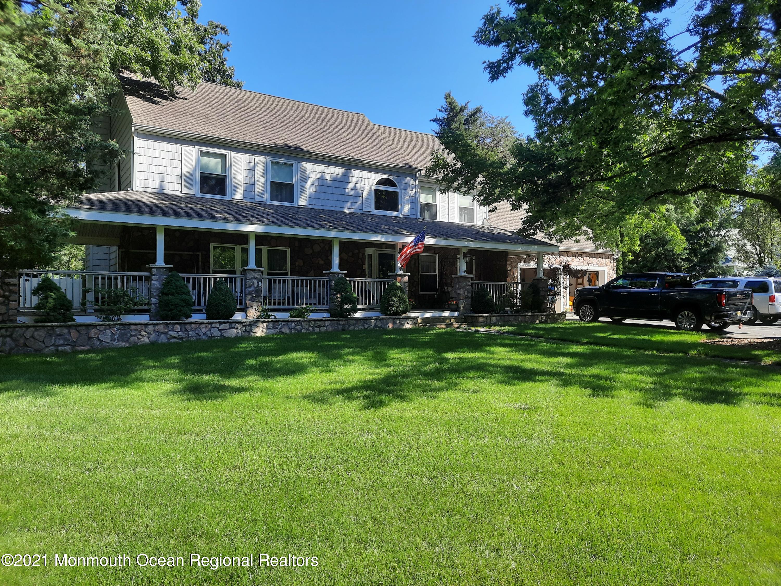 5 Dunhill Road Jackson, NJ 08527 - Photo 1 of 11 a front view of a house with a garden and trees