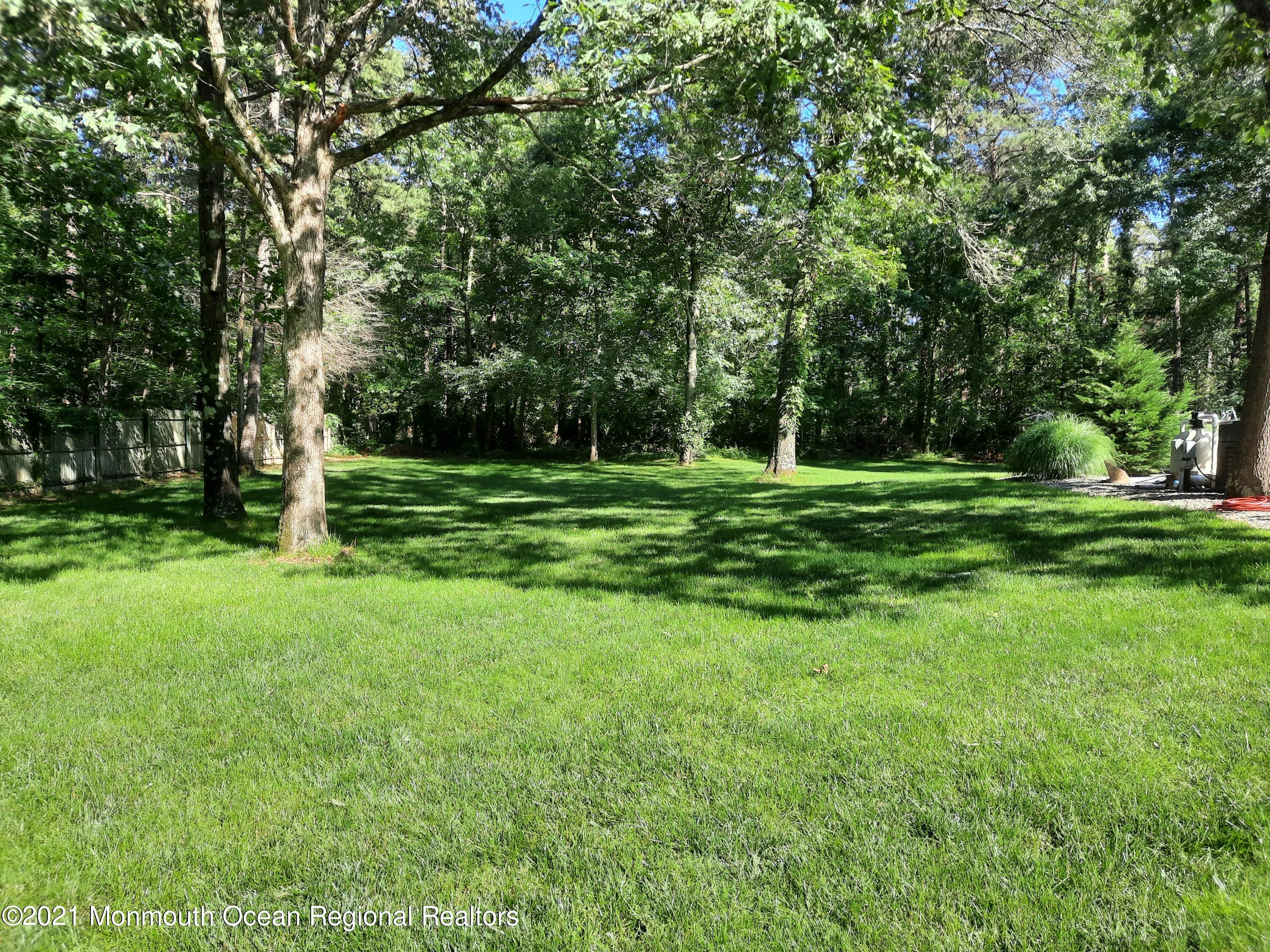 5 Dunhill Road Jackson, NJ 08527 - Photo 11 of 11 a big yard with lots of green space and trees in the back