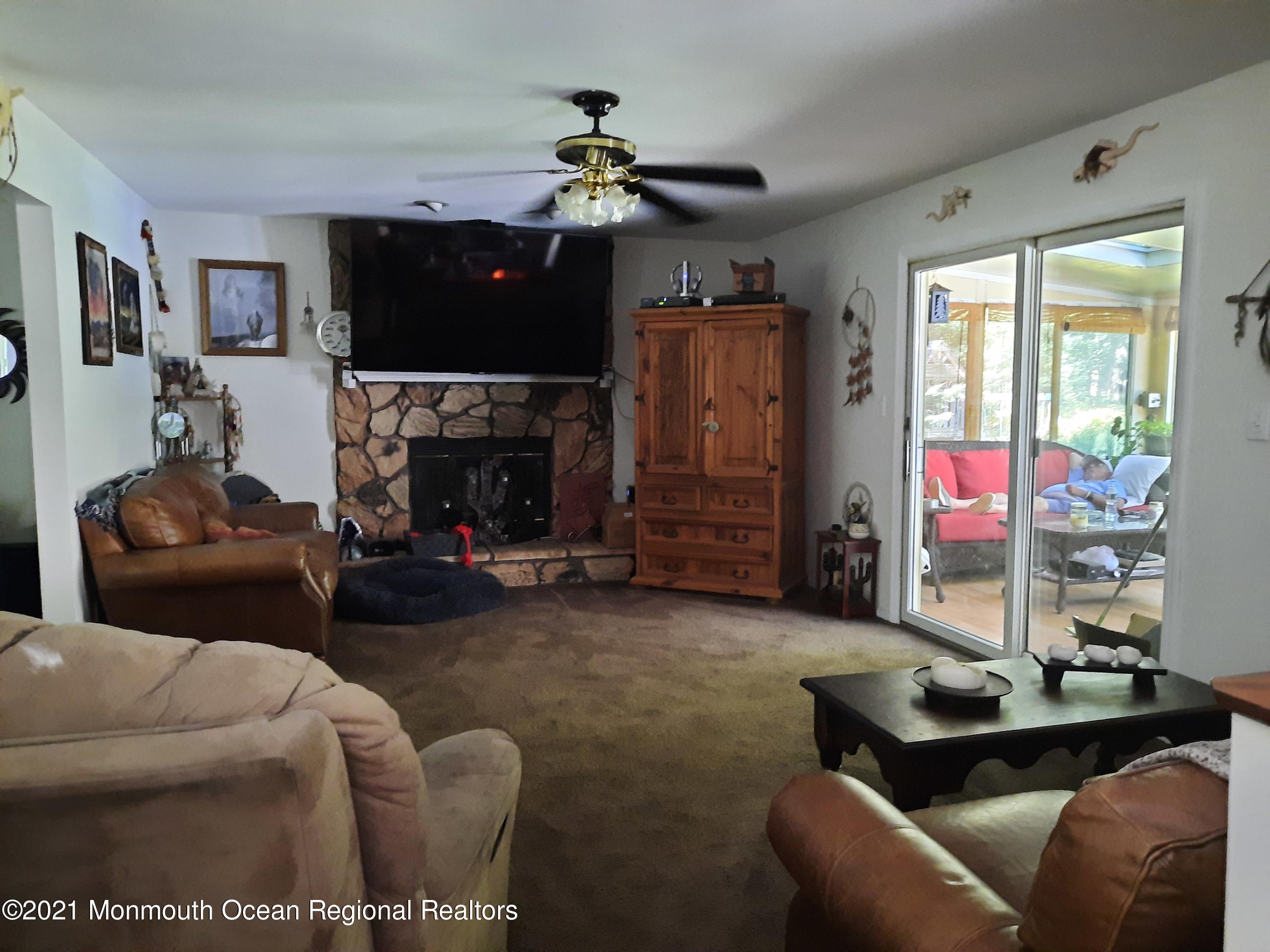 5 Dunhill Road Jackson, NJ 08527 - Photo 5 of 11 a living room with furniture a fireplace and a flat screen tv