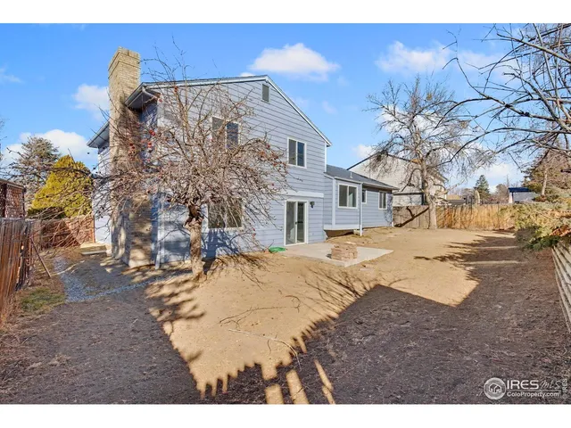 a view of a yard and snow on the road