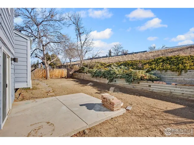 a view of a house with a yard covered in snow