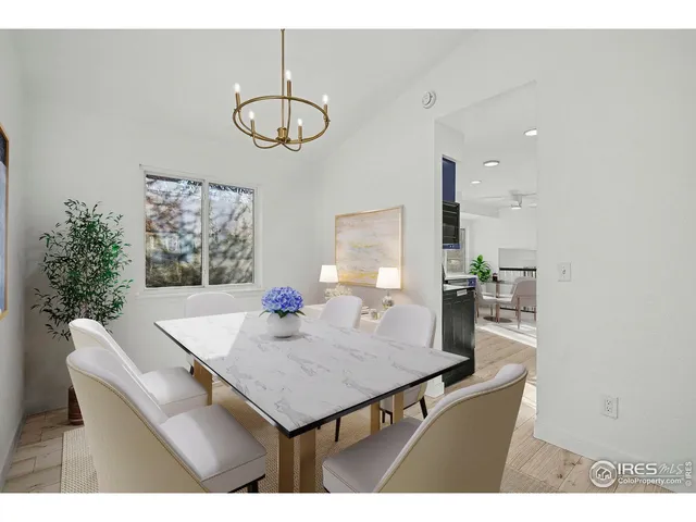 a kitchen with a table chairs sink and cabinets