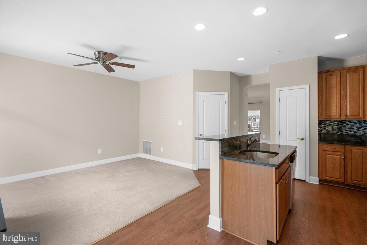13626 Dover Cliffs Place Germantown, MD 20874 - Photo 11 of 32 a kitchen with granite countertop a sink and cabinets