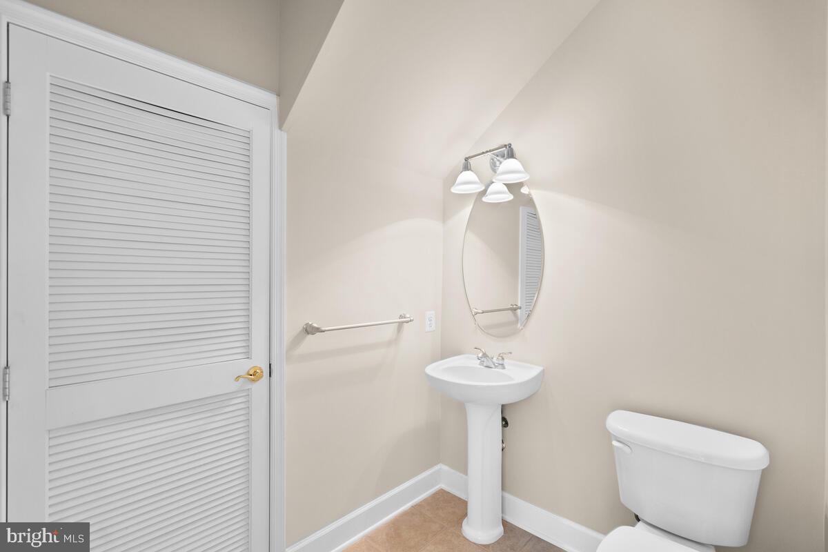 13626 Dover Cliffs Place Germantown, MD 20874 - Photo 16 of 32 a bathroom with a toilet sink and mirror