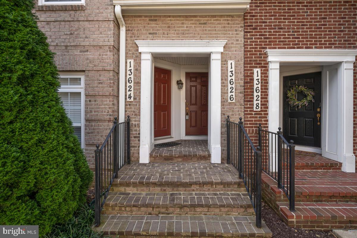 13626 Dover Cliffs Place Germantown, MD 20874 - Photo 3 of 32 a view of a brick house with potted plants