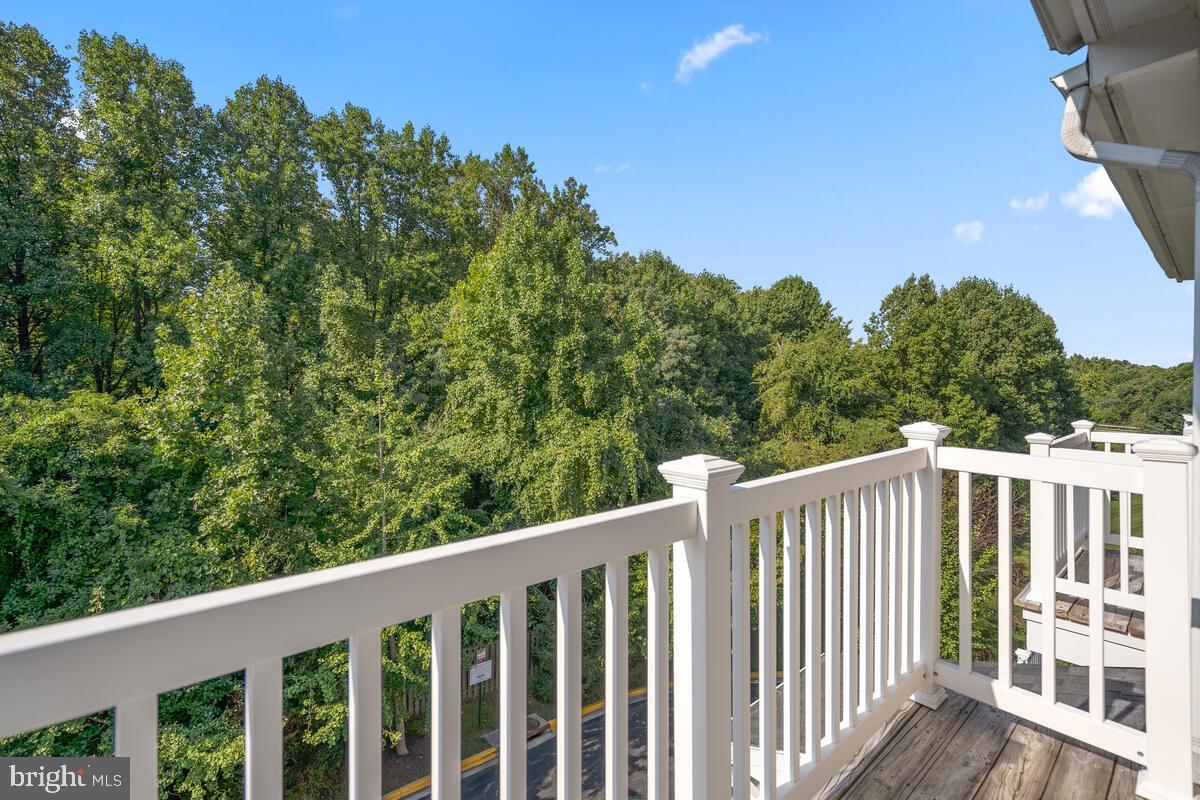 13626 Dover Cliffs Place Germantown, MD 20874 - Photo 22 of 32 a balcony with wooden floor and fence